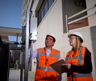 Two Inspectors in Orange Work Vests