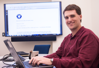 A Person working on a Lap Top computer